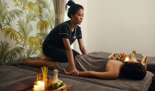 Masseuse Giving Thai Massage